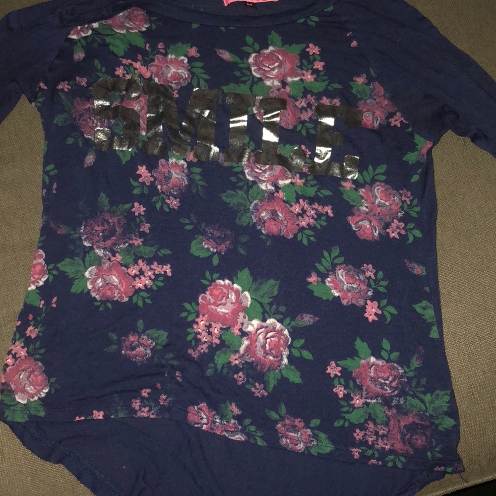 Flowery shirt ,silver letters saying SMILE.